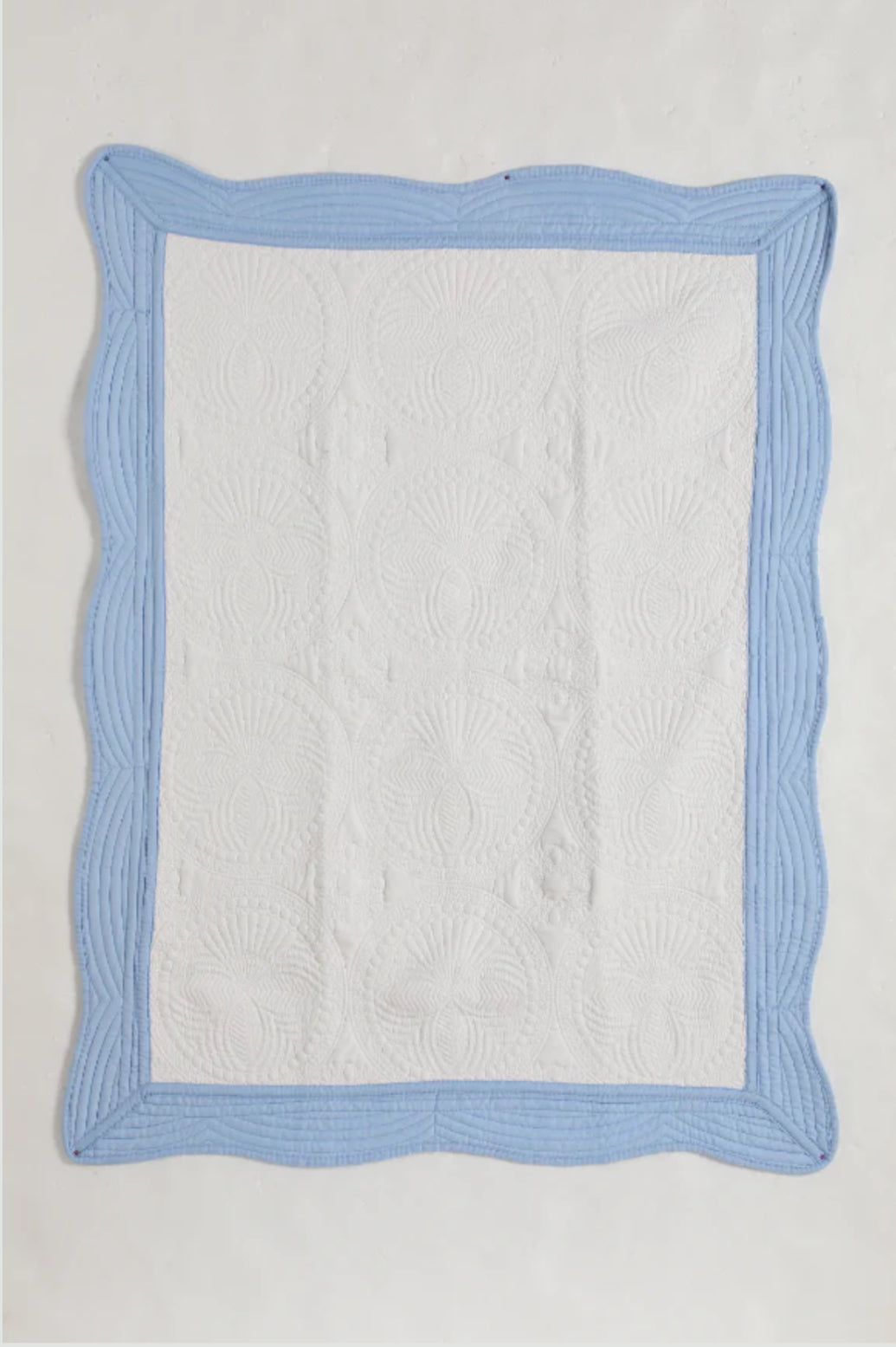 Heirloom quilt trimmed in light blue
