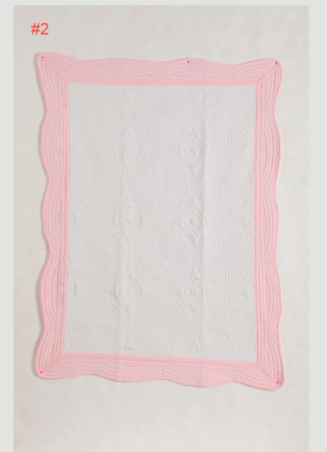 Heirloom baby quilt trimmed in pink