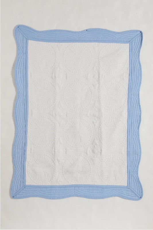 Heirloom quilt trimmed in light blue